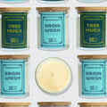 A grid-style product collage showing multiple Moodcraft candles on a white background, with two jars labeled Tree Hugs and two jars labeled Brain Wash, plus one open candle centered below showing pale cream wax.