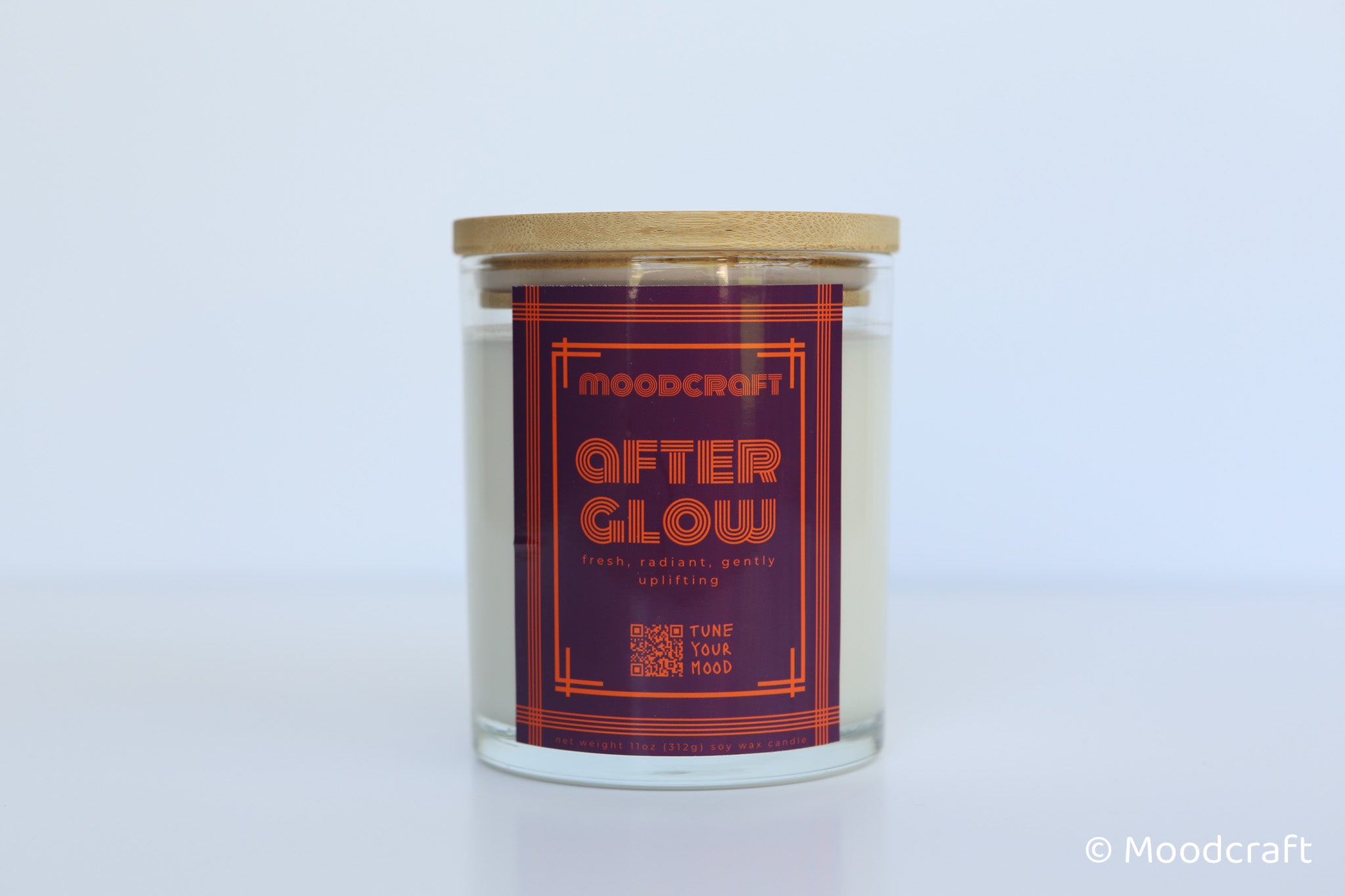Moodcraft 'After Glow' candle with a wooden lid on a white background