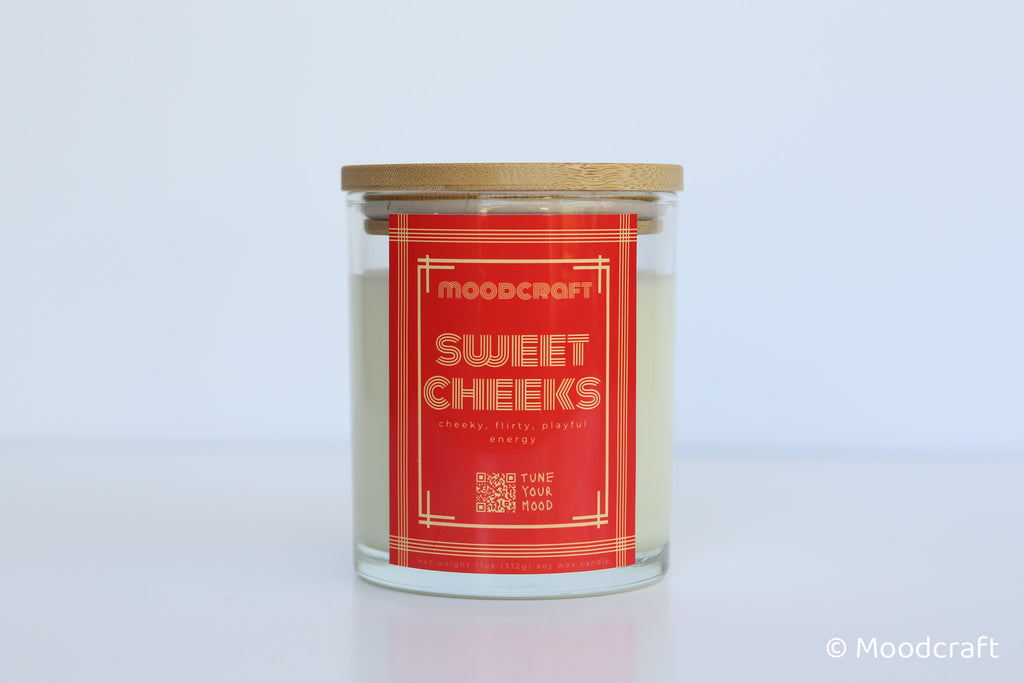 Moodcraft candle with a red label on a light gray background