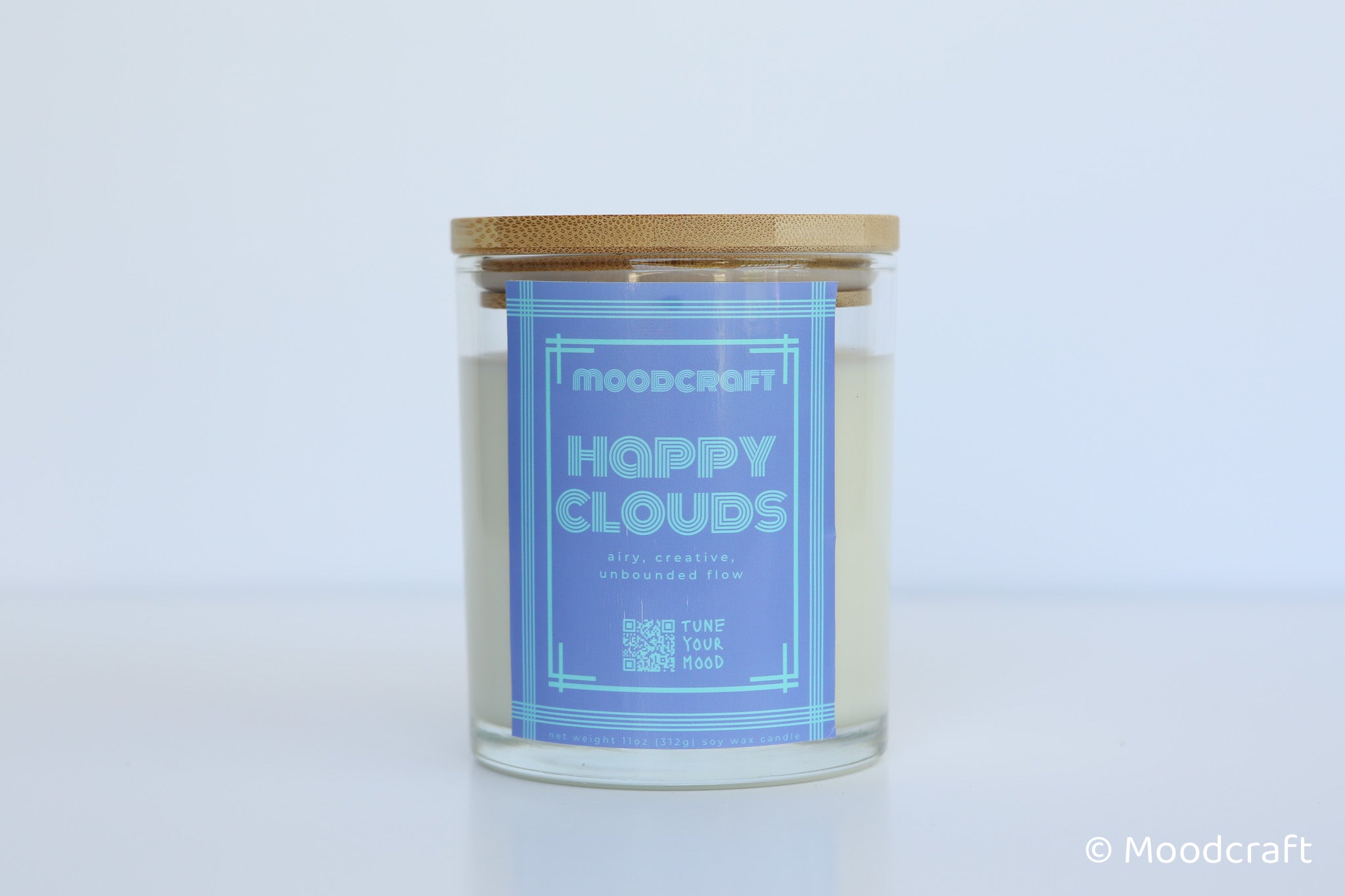 Moodcraft Happy Clouds candle with a blue label on a light gray background