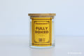 Moodcraft candle with a wooden lid on a light gray background