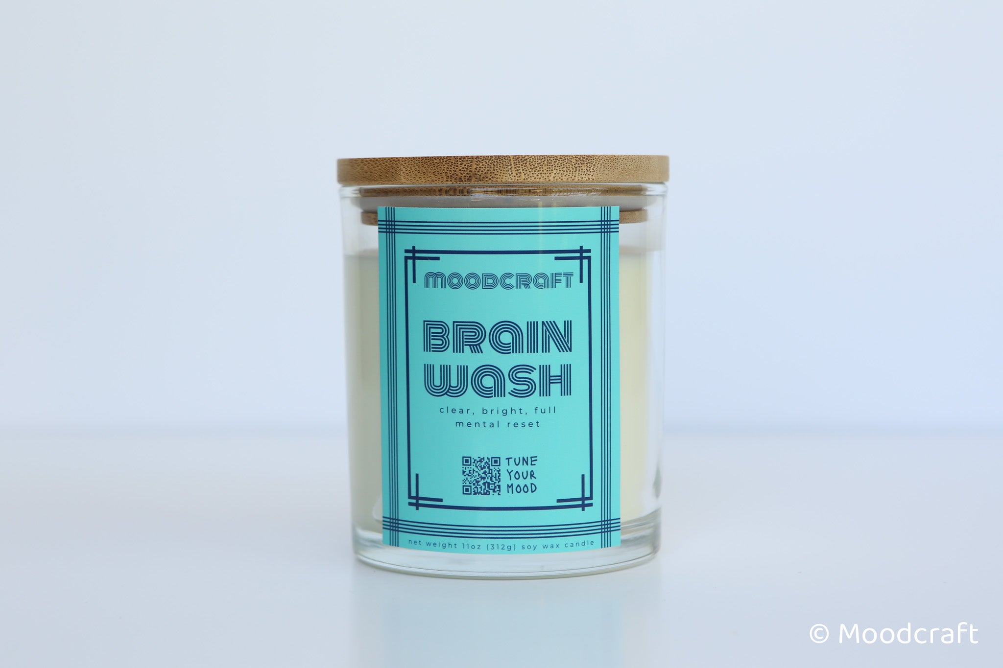Moodcraft candle labeled 'Brain Wash' on a light blue background