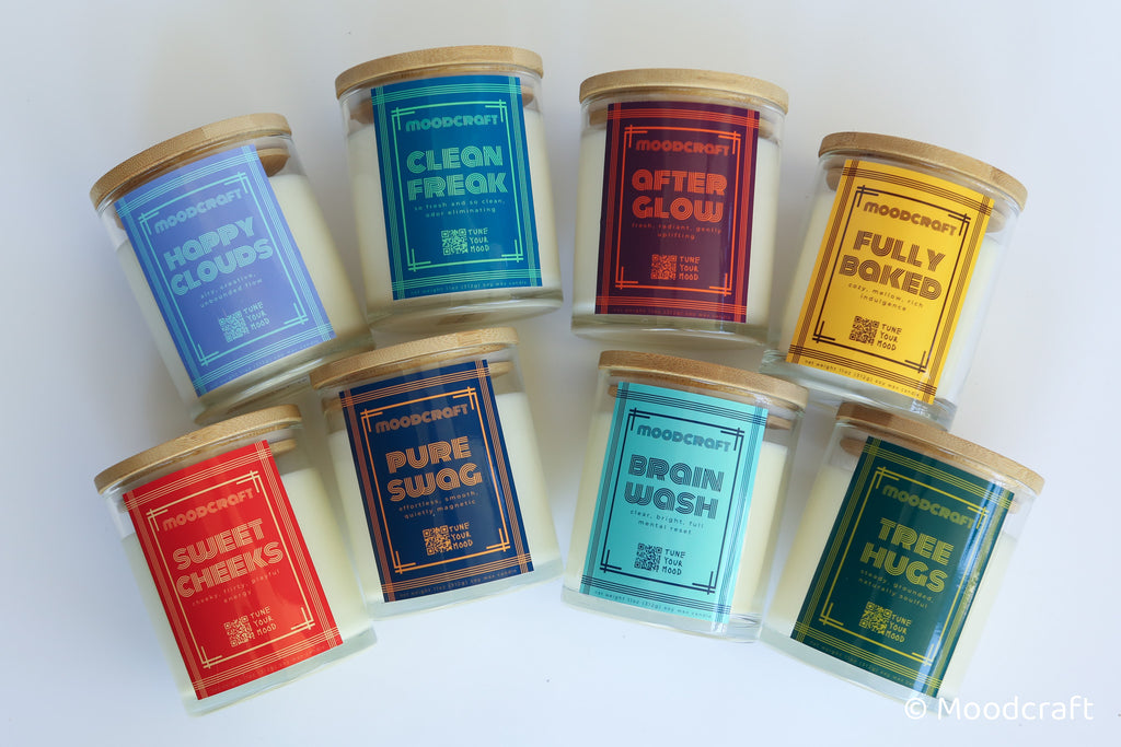 Assorted candles with colorful labels on a white background