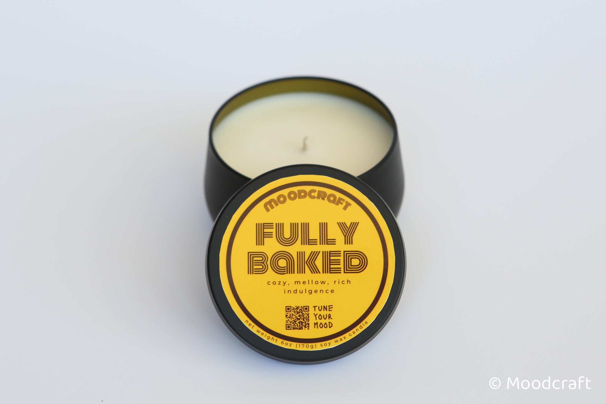 Moodcraft candle in a tin with 'Fully Baked' label on a white background