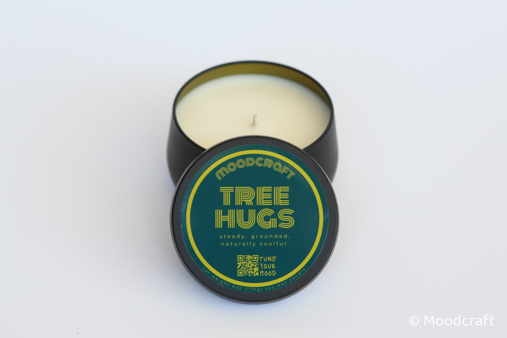 Moodcraft candle in a tin with 'Tree Hugs' label on a white background