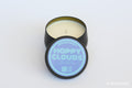 Candle in a tin with 'Happy Clouds' label on a white background