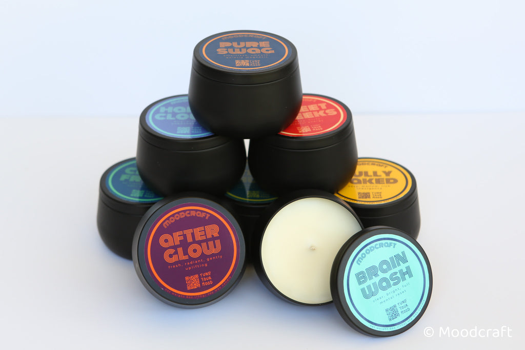 Collection of black containers with colorful labels on a white background