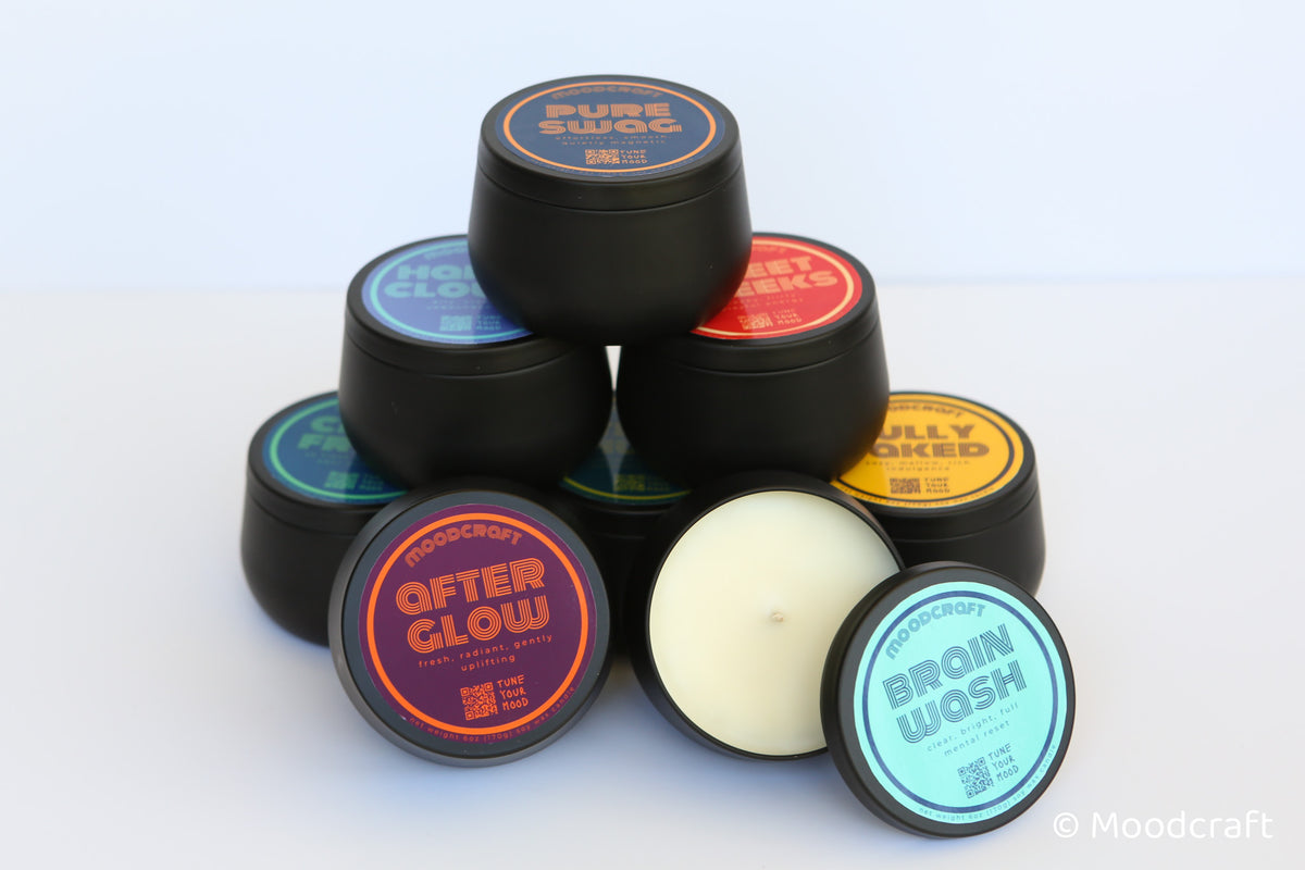 Collection of black containers with colorful labels on a white background
