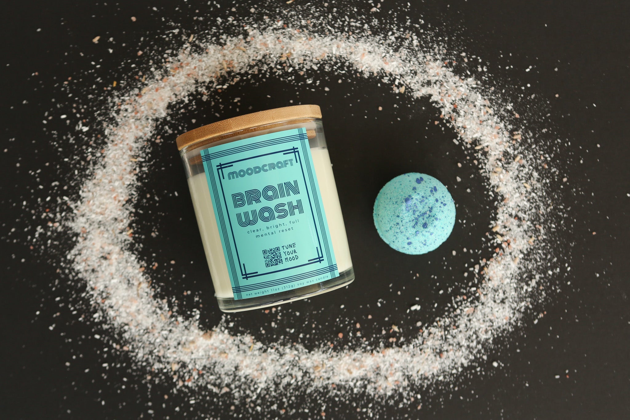 Brain Wash product with a circular arrangement of bath salts around it on a dark background