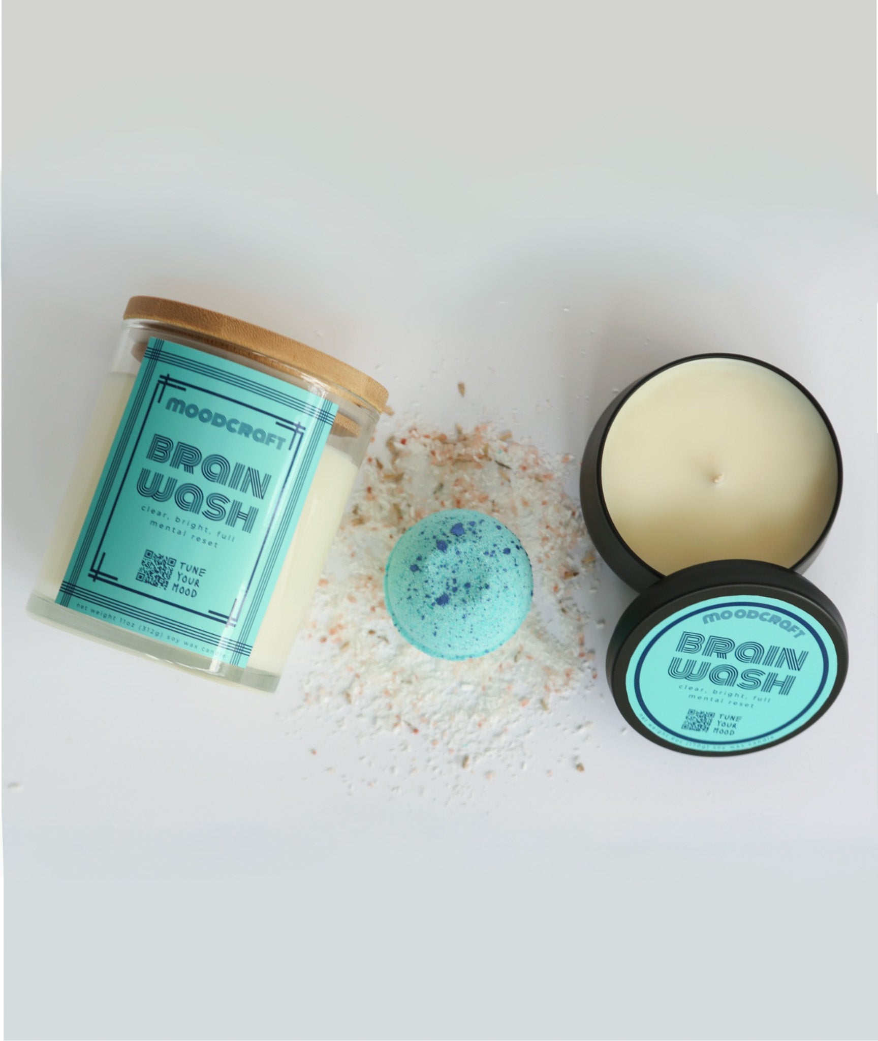 Bath products including a jar, loofah, and bar of soap labeled 'Brain Wash' on a white background.